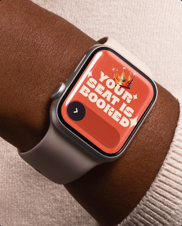 Smartwatch on a wrist displaying "Your seat is booked"