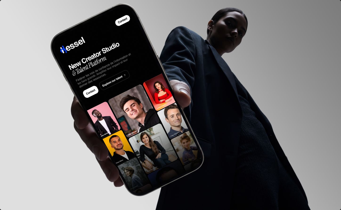 Hand holding a phone showing the Kessel mobile homepage