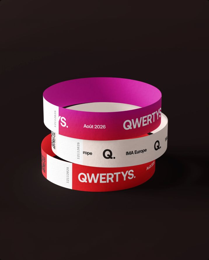 Stack of Qwertys event wristbands in pink